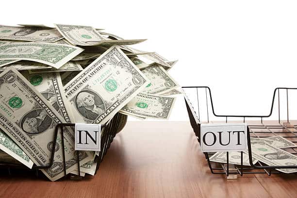 A basket with cash flowing in and an empty basket labelled out.