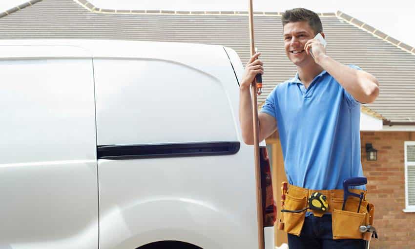 Tradesman taking a quote over the phone.